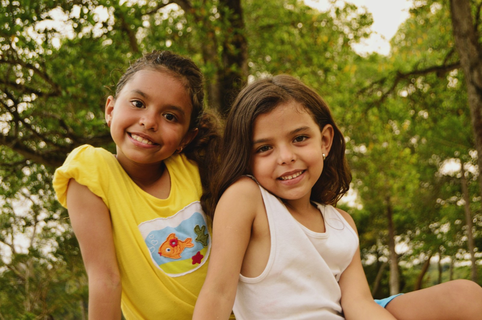 Two girls smiling outdoors